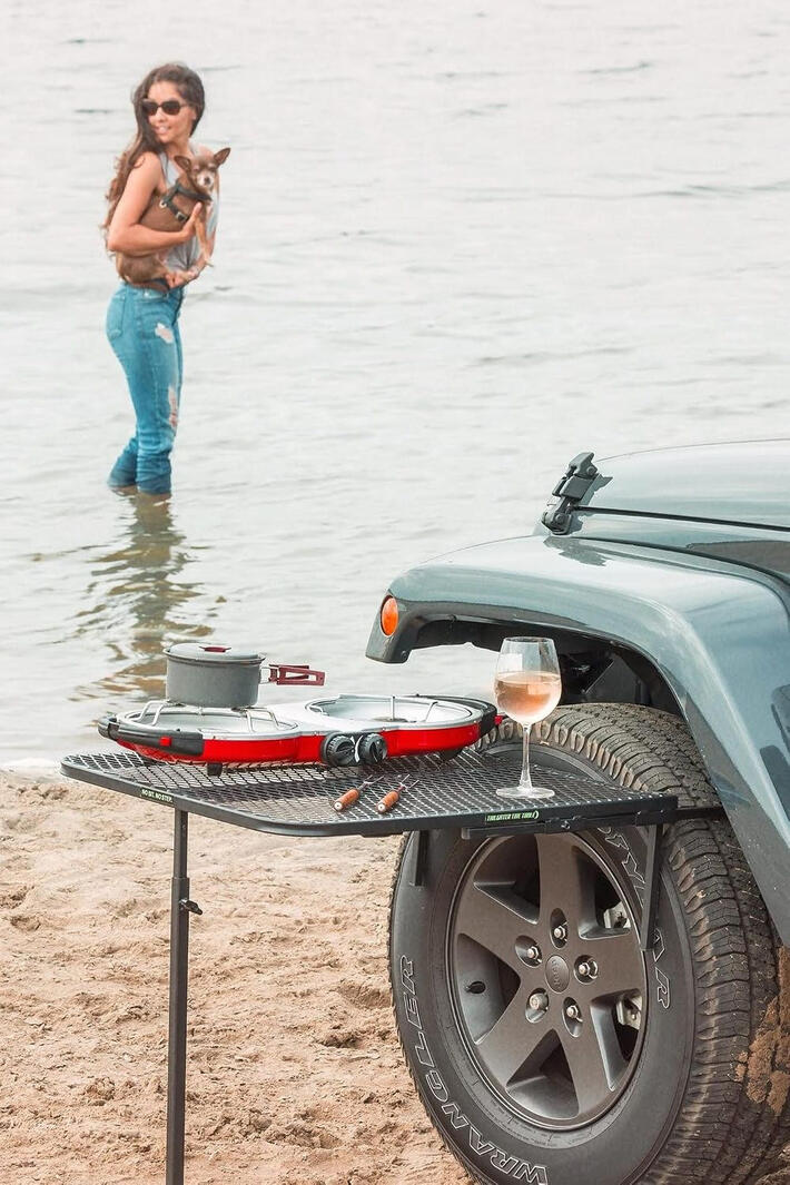 The Steel Tire Mount Camping Table slides on in seconds no tools, no hitch required. 50 lb capacity, powder-coated steel, adjustable support leg, and folds flat for storage. Perfect for camping, overlanding, tailgating, hunting, fishing, and job sites.